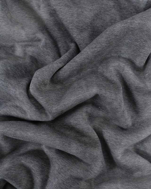 Tissu jean envers mousse sur résille noir.